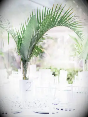 tall modern greenery wedding centerpiece with palm fronds