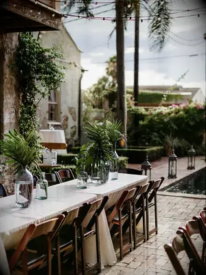 greenery wedding centerpiece with tropical palm leaves and fronds