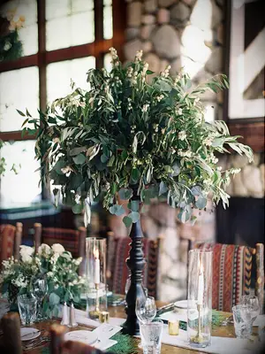 tall eucalyptus wedding centerpiece with olive branches