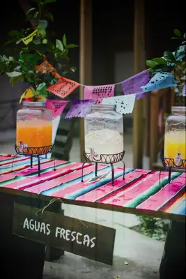 Colorful agua fresca drink table for signature wedding drink idea