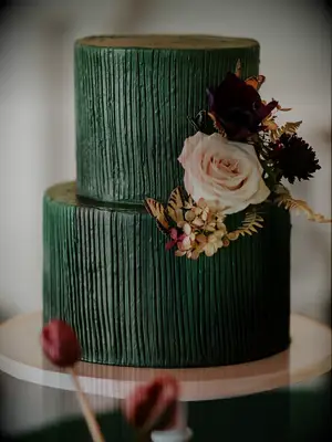 dark green fall wedding cake with textured fondant, pink and burgundy roses and faux yellow butterfly