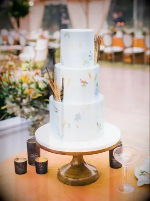 modern rustic fall wedding cake with hand-painted birds and flowers on fondant tiers