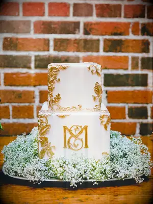 classic square fall wedding cake with gold filigree details and monogram
