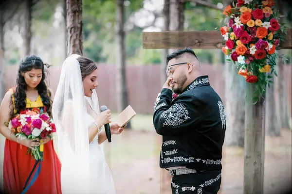 Groom crying while exchanging vows with bride