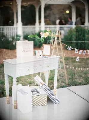 vintage table repurposed as wedding gift table with instant camera guest book
