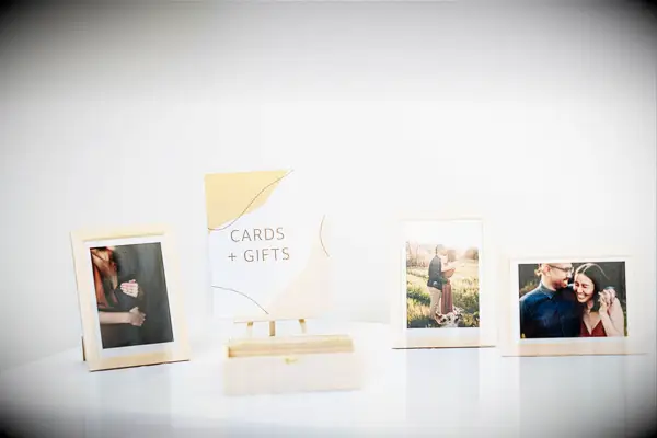 wedding welcome table with framed engagement photos
