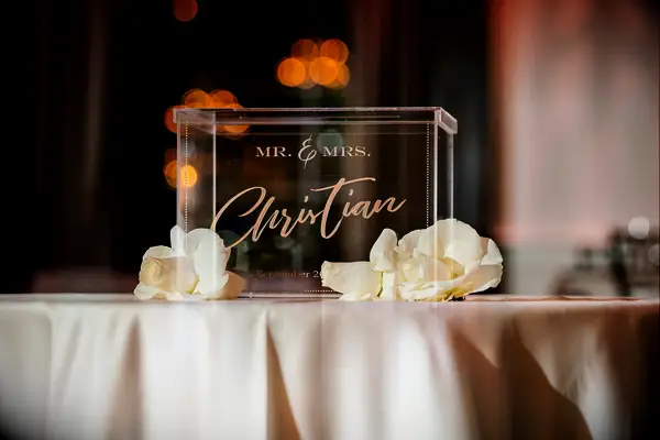 wedding gift table with acrylic wedding card box featuring mr & mrs christian written in gold calligraphy
