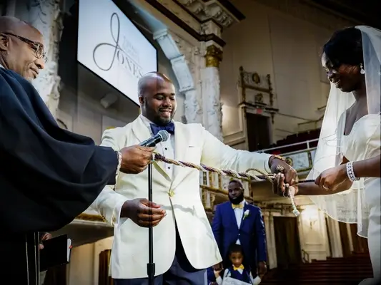 bride and groom doing tying the knot ritual during wedding ceremony