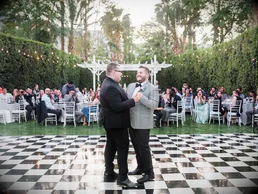 Grooms during first dance song at outdoor wedding reception