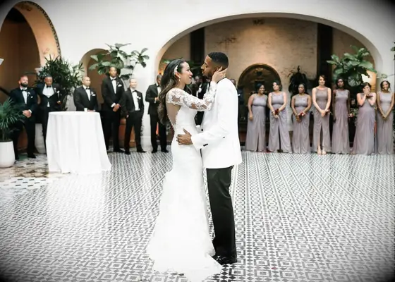 Bride and groom share first dance at outdoor reception venue
