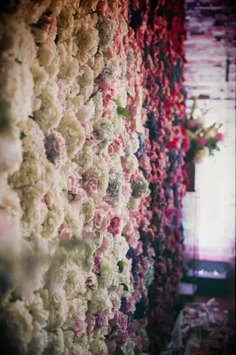 Ombré purple, pink and white wedding flower wall. 