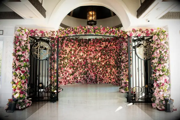 A colorful flower wedding wall at the reception entrance.