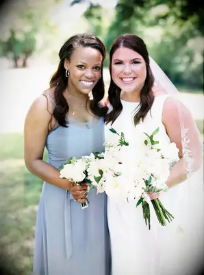Bride posing with bridesmaid