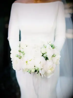 Bride holding white peony bouquet