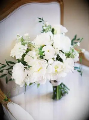 Classic white-and-green bouquet sitting on chair