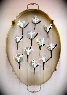 Antique tray with boutonnieres sitting on it