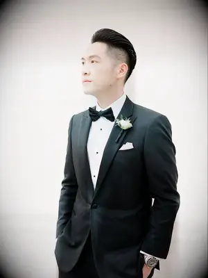 Groom in tux with white boutonniere