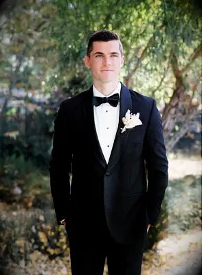 Groom in tux with white boutonniere