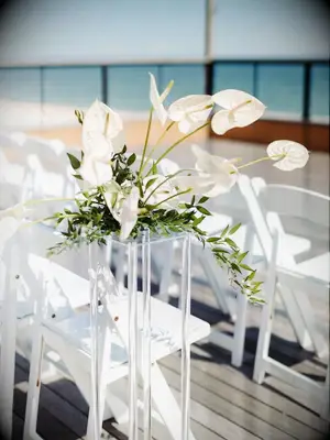anthurium floral arrangement on pedestal at oceanside wedding ceremony