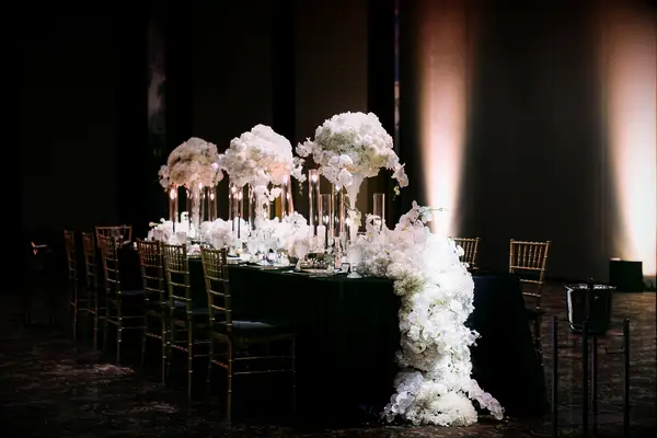 Reception table with floral runner and tall floral centerpieces