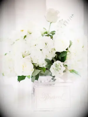 All-white centerpiece and acrylic table number