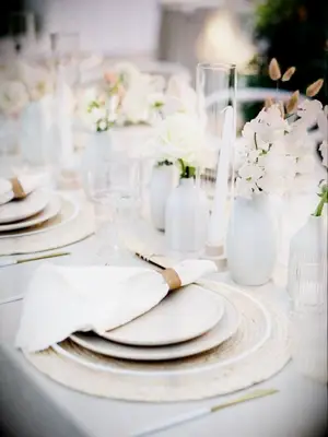 White-and-gray tables cape with bud vase arrangements