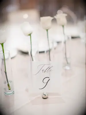 Minimal rose centerpieces and simple black-and-white table number
