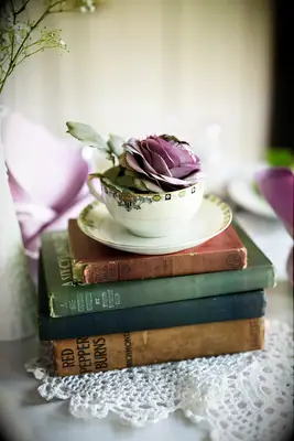 Vintage books and antique teacup centerpiece for your Disney-themed wedding