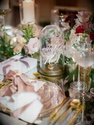 Flowers and glass cloche table numbers for your romantic wedding reception