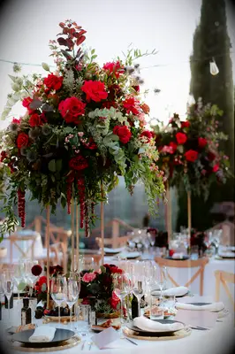 Romantic tall flower centerpieces in shades of red and green