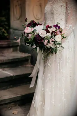 Wedding Bouquet of purple and pink flowers with vibrant greenery