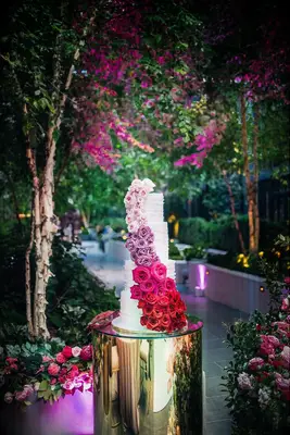 Four-tier Wedding Cake With Ombré Roses in pink, blush, and red