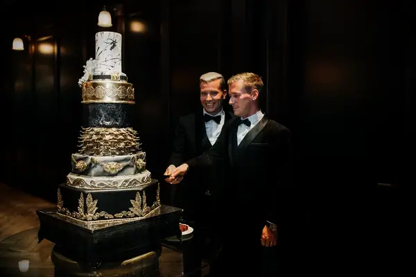 Eight-tier wedding cake with glam black, gold and marble accents