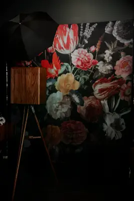 Vintage photo booth with floral wallpaper backdrop