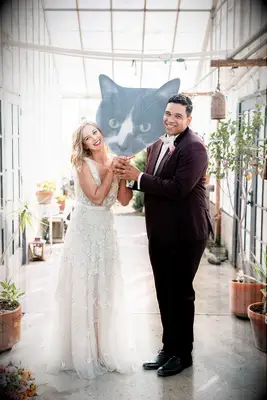 Couple holding giant cat cutout