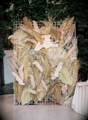 Decorative wall with dried grasses and custom sign