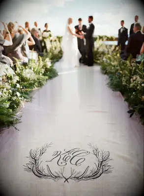 Linen aisle runner featuring a custom monogram. 