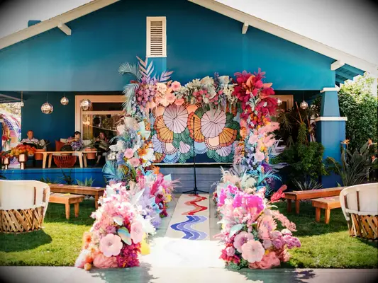 Colorful aisle runner featuring bright flowers and feathers. 