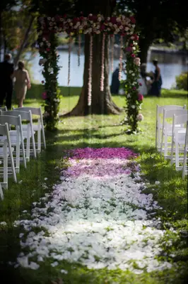 Ceremony aisle lined with ombre flower petals. 