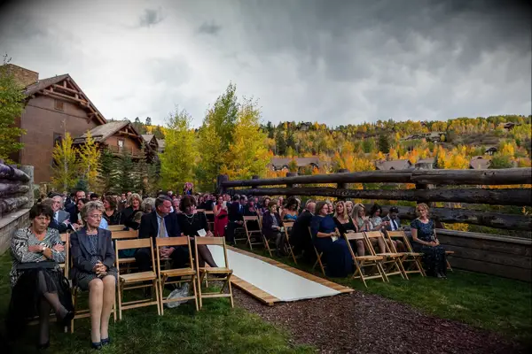 Wooden aisle runner at an outdoor ceremony in the wilderness. 