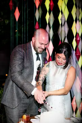 A couple cut their wedding cake together on their big day