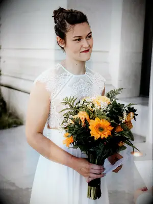 To-be-wed holding bouquet with yellow Gerbera daisies