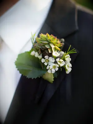 Boutonniere with wax flowers and succulents
