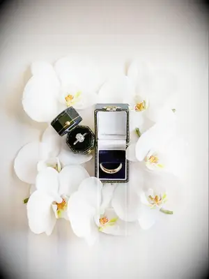 Engagement ring flat lay with white phalaenopsis orchids