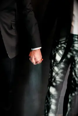 couple holding hands on wedding day