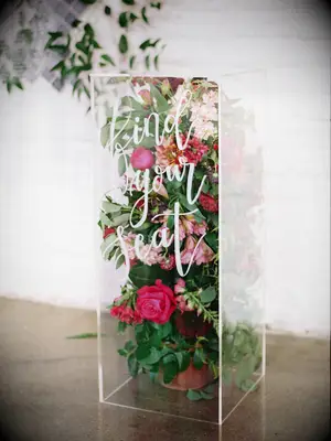 clear acrylic rectangular box filled with pink flowers and greenery with 