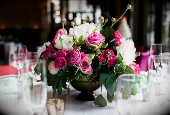 low wedding centerpiece with pink garden roses, ranunculus, white peonies and greenery