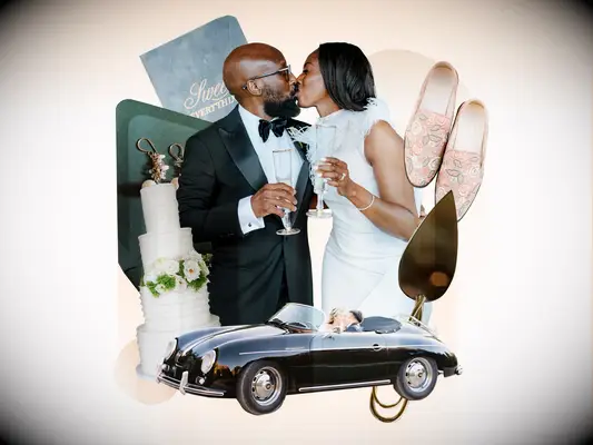 Couple kissing holding champagne glasses surrounded by classic romantic wedding theme decor