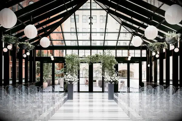 Breezy indoor atrium ceremony setting. 