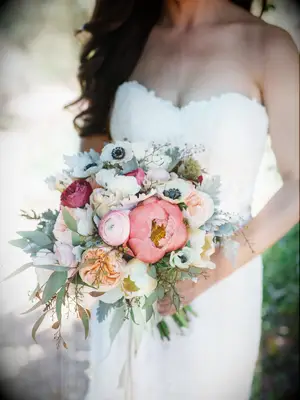 A multi-colored bouquet with peonies, anemones and roses.